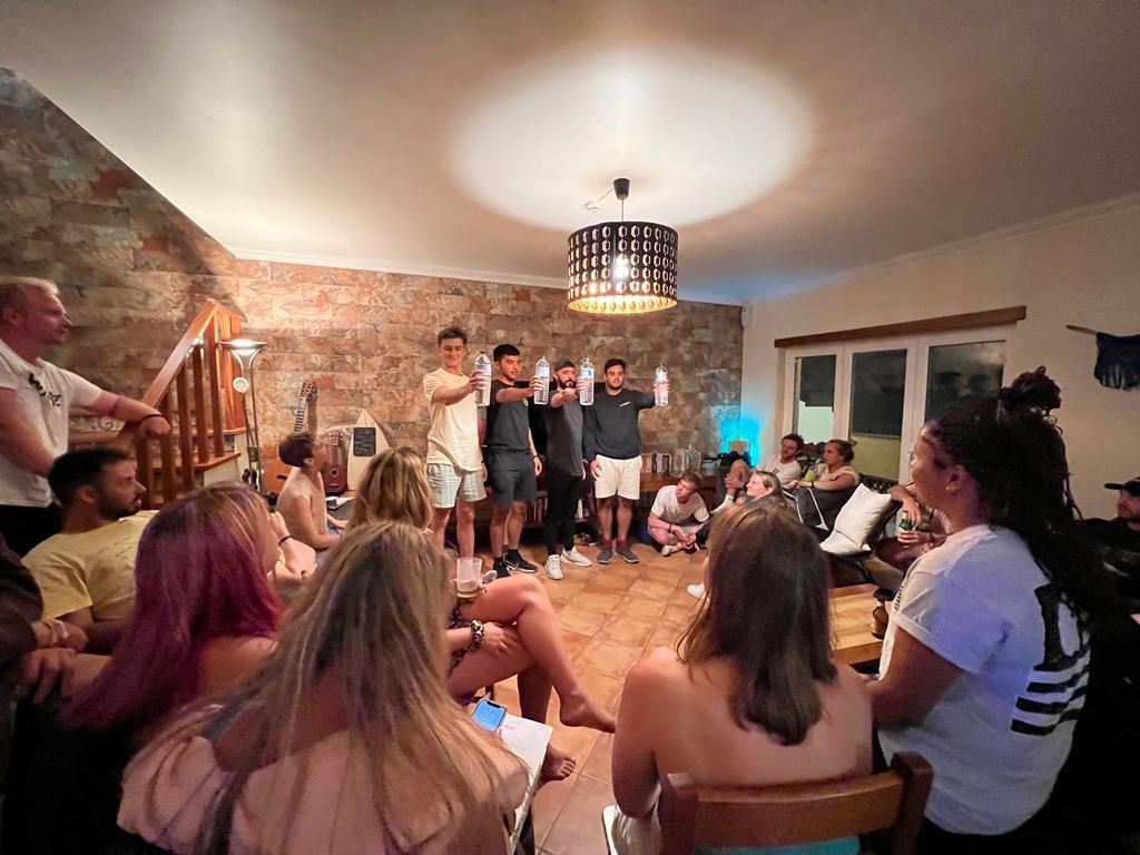 A group of people are sitting in a circle in a living room.