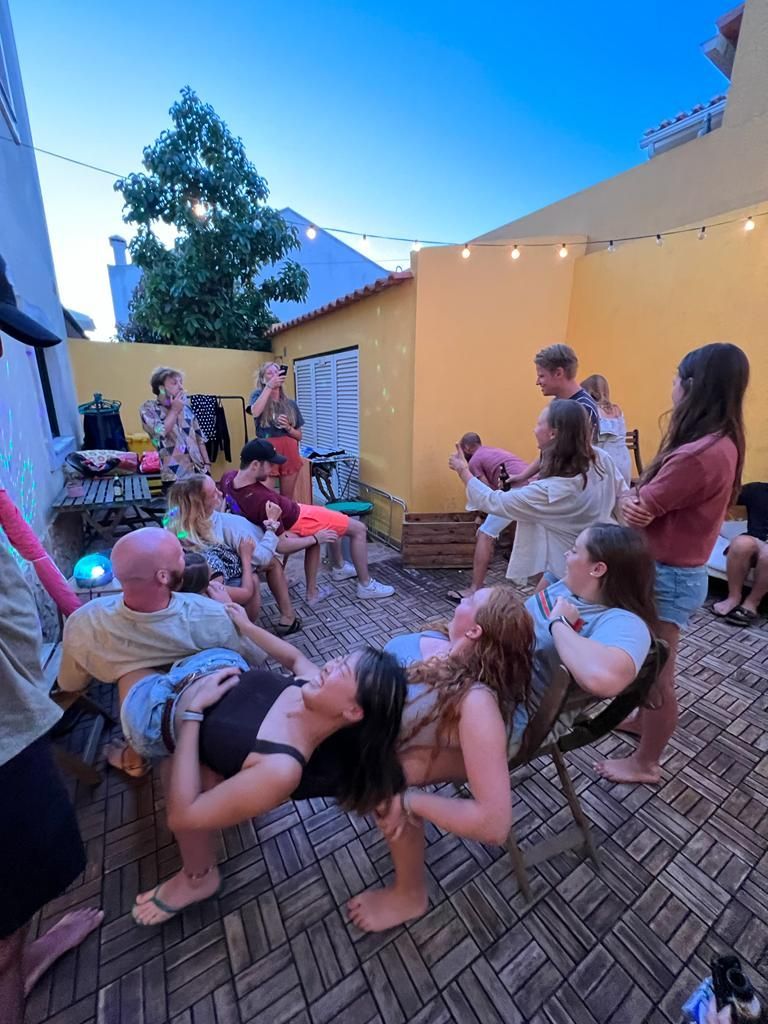 A group of people are sitting in chairs on a patio.