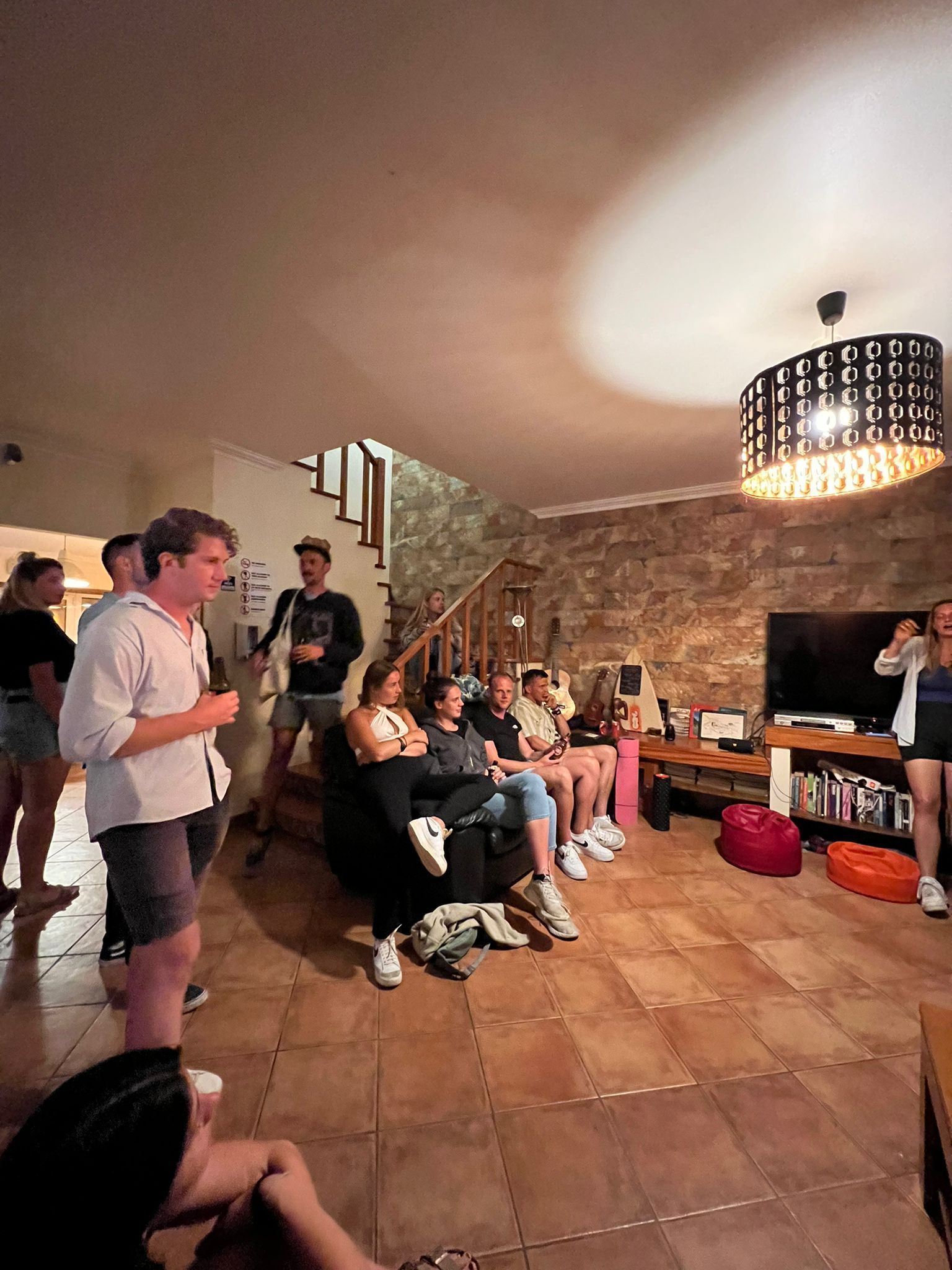 A group of people are sitting in a living room.