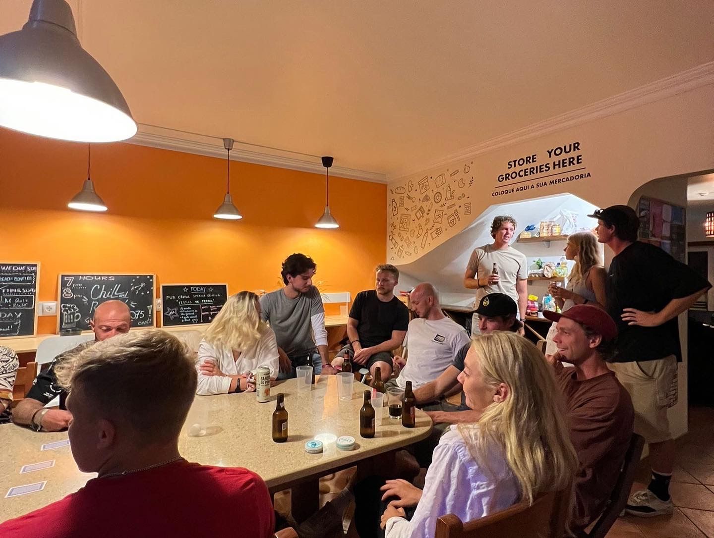 A group of people are sitting around a table in a restaurant.