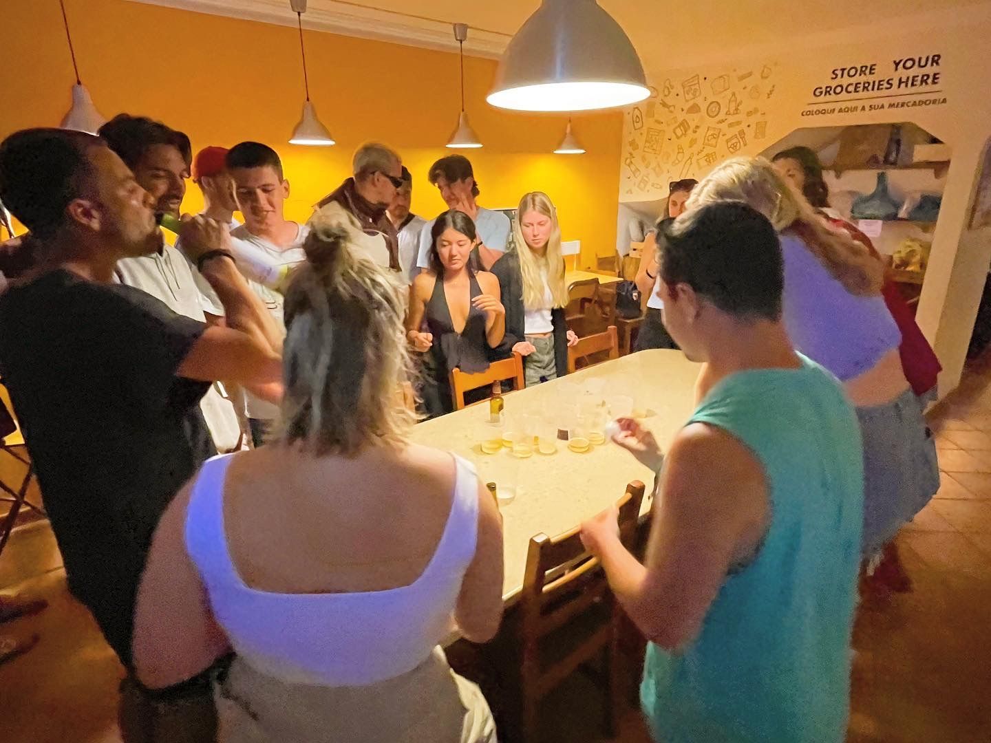 A group of people are standing around a table with a sign that says visit your