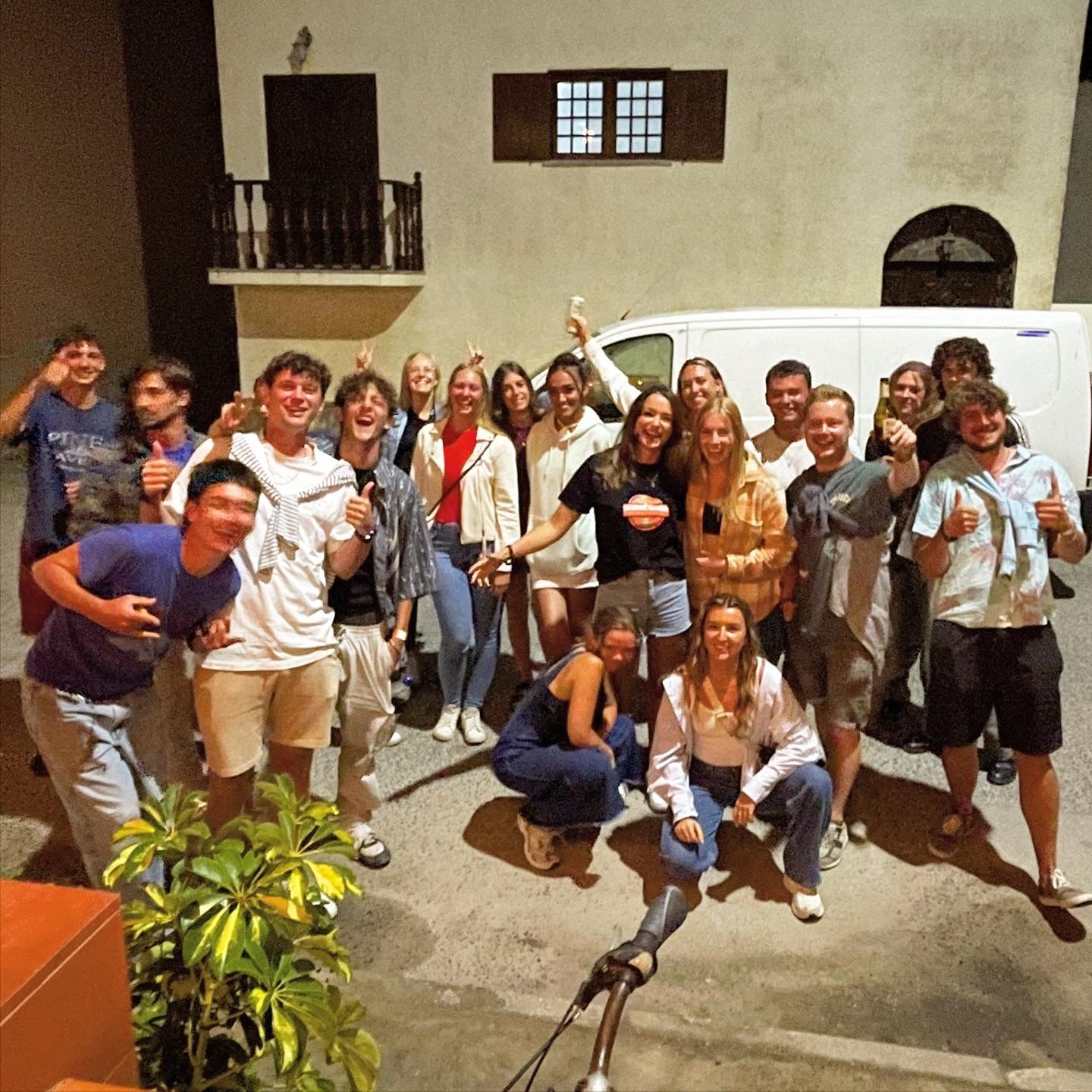 A group of people posing for a picture in front of a building