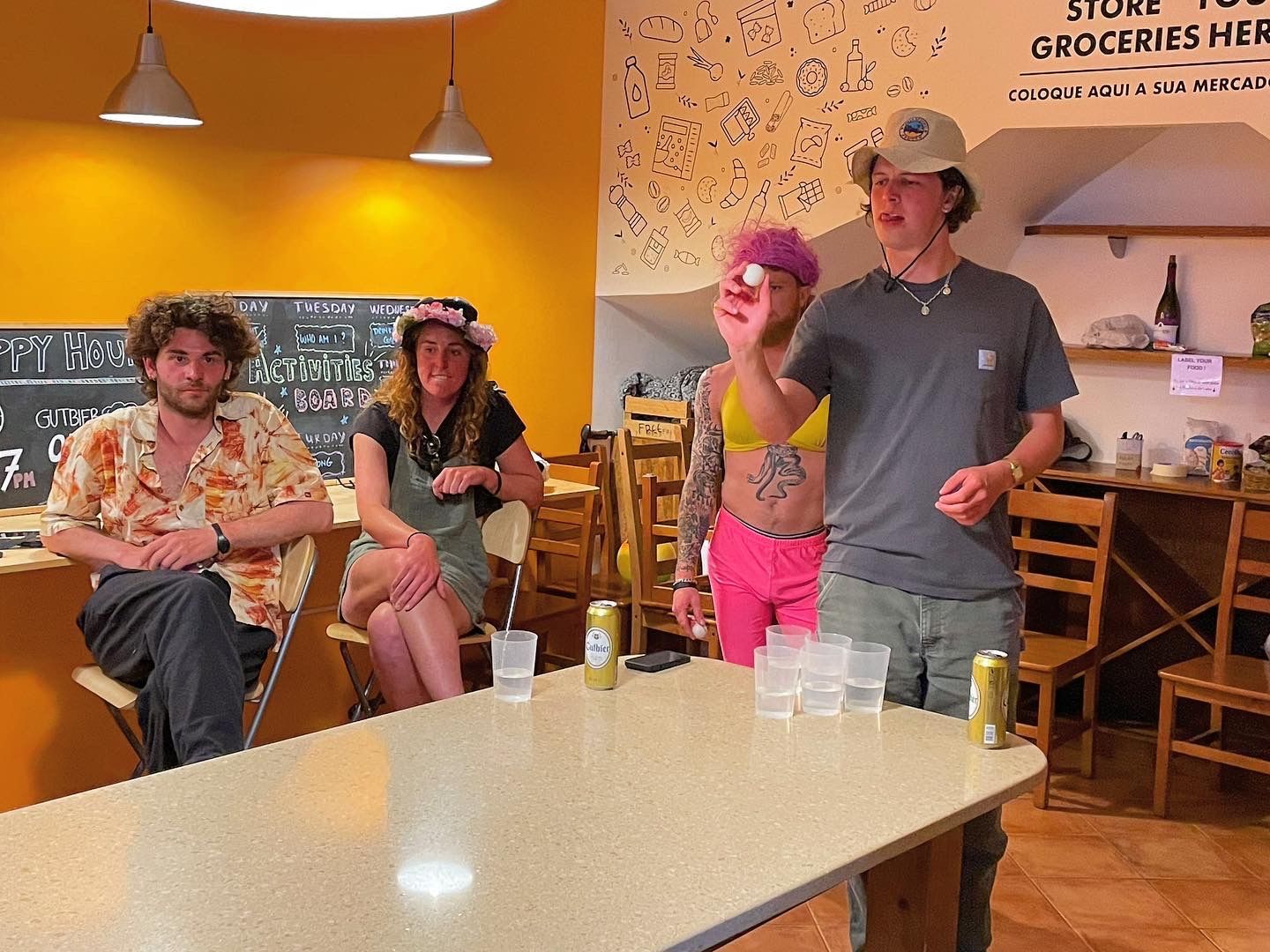 A group of people sitting around a table with a sign that says store groceries here