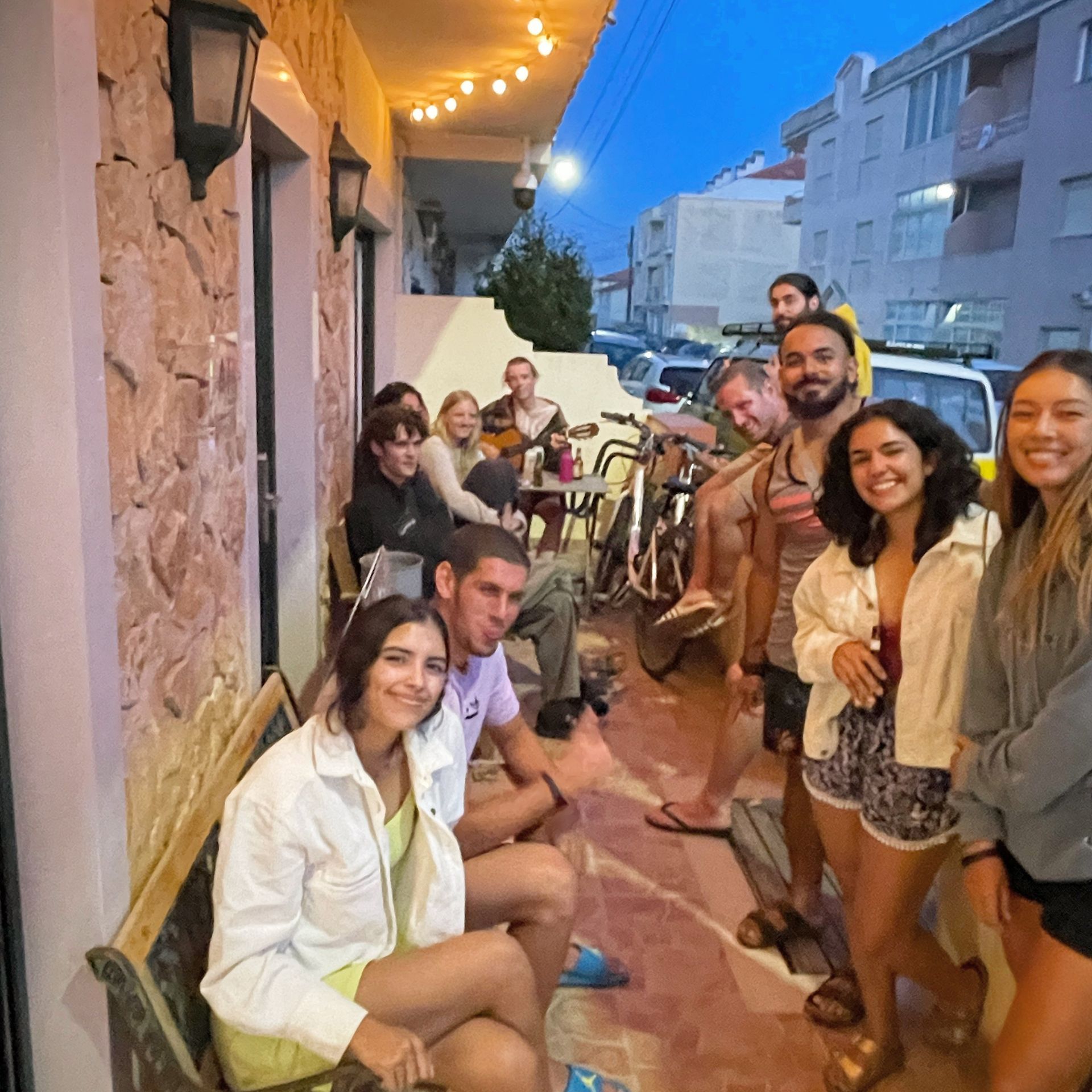A group of people are posing for a picture outside of a building
