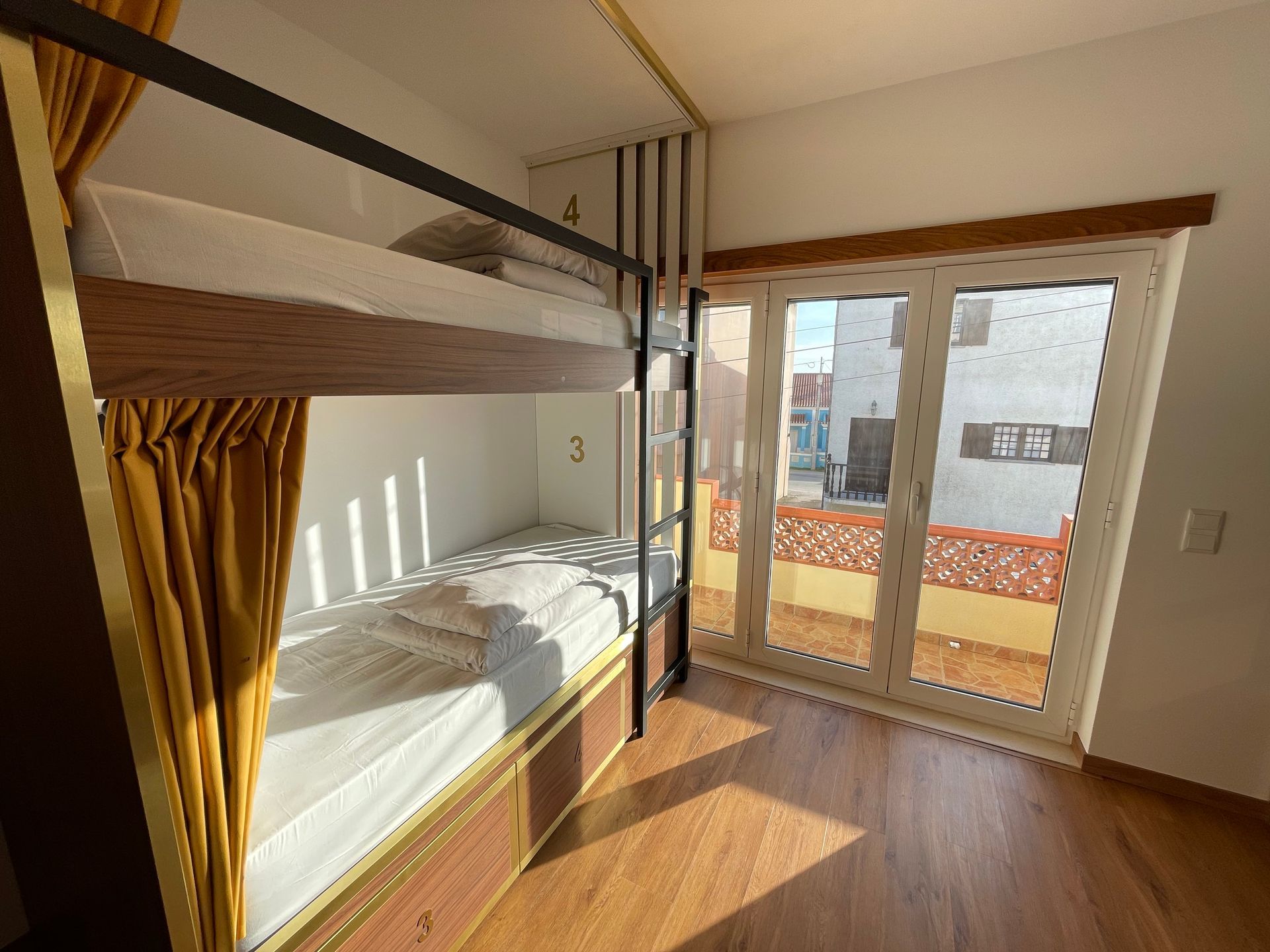 A bedroom with bunk beds and a large window.