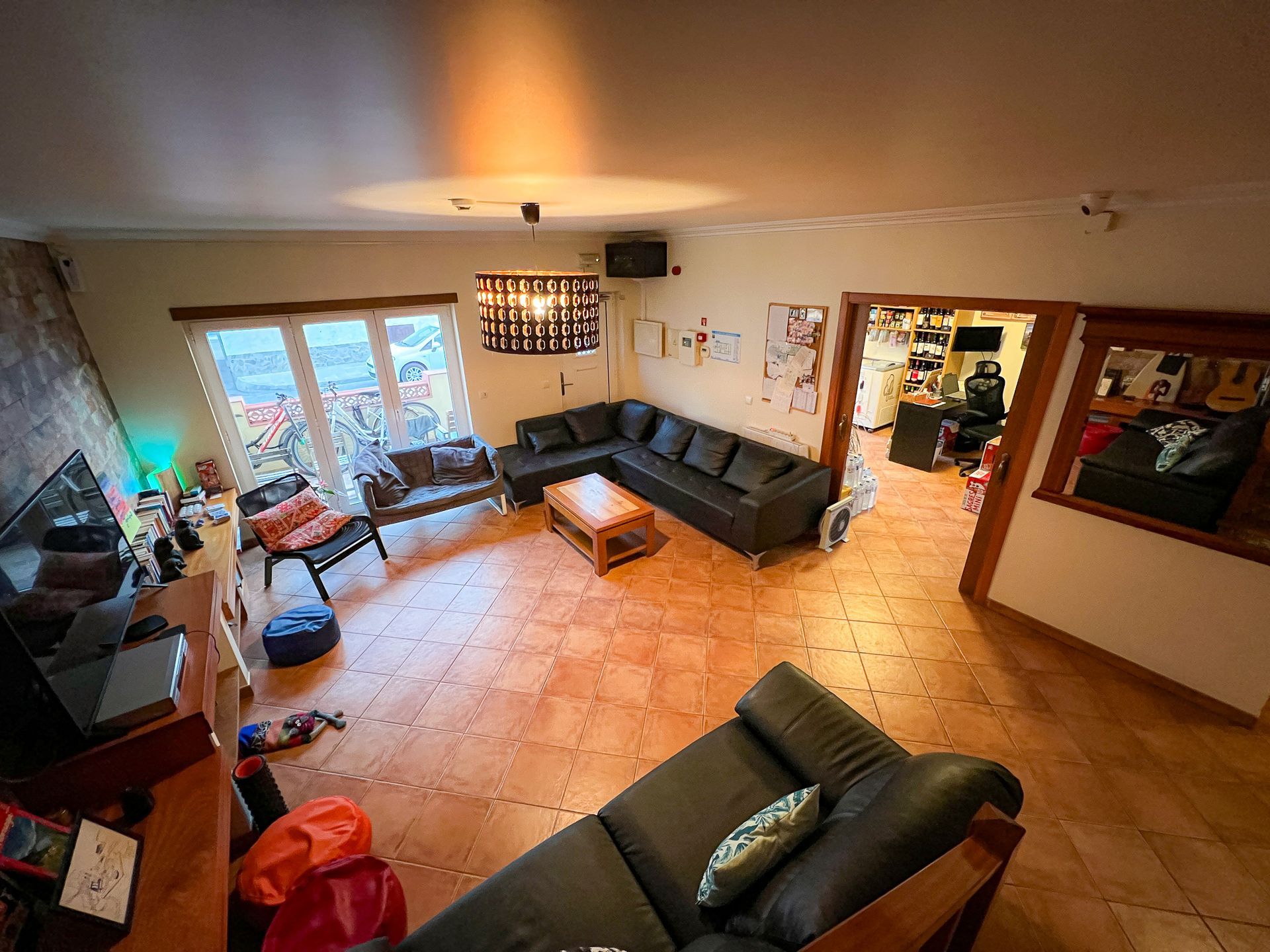 A living room with a couch , chairs , and a television.