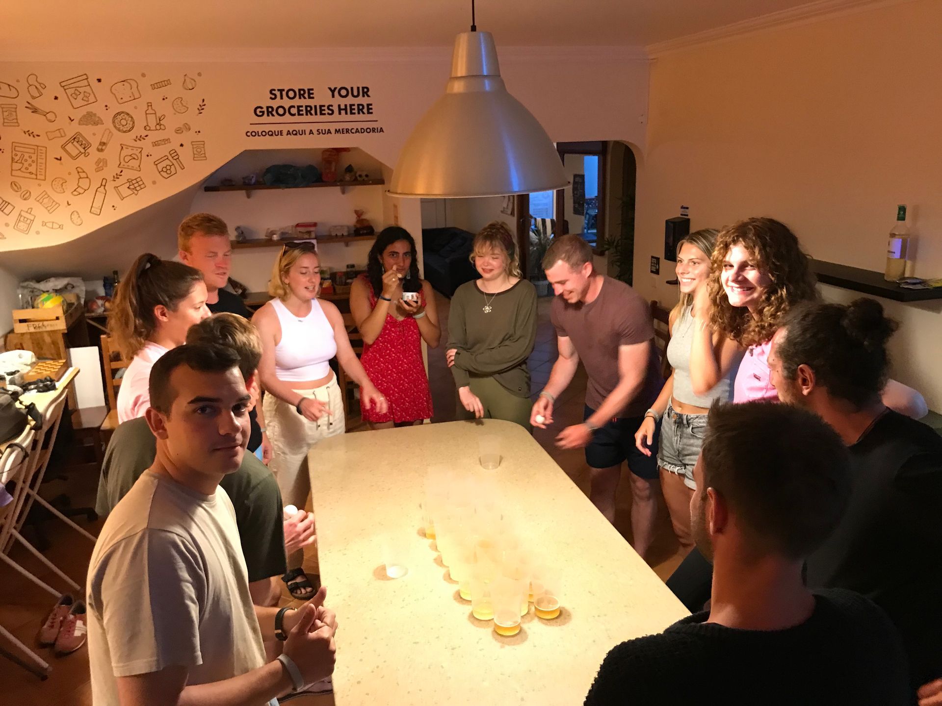 A group of people are standing around a table in a room.