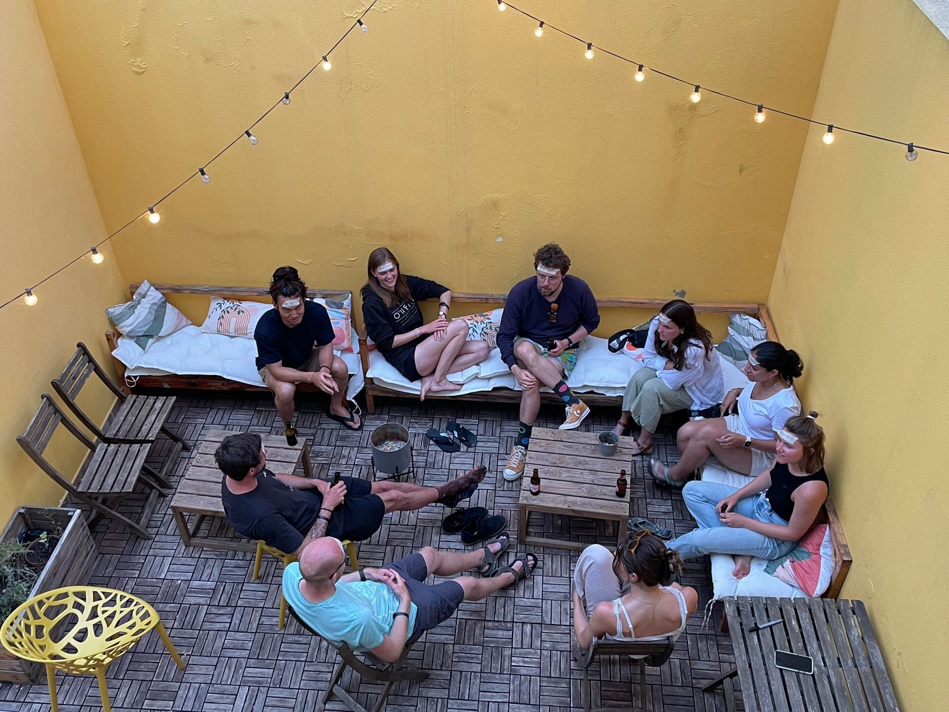 A group of people are sitting in a circle on a patio.