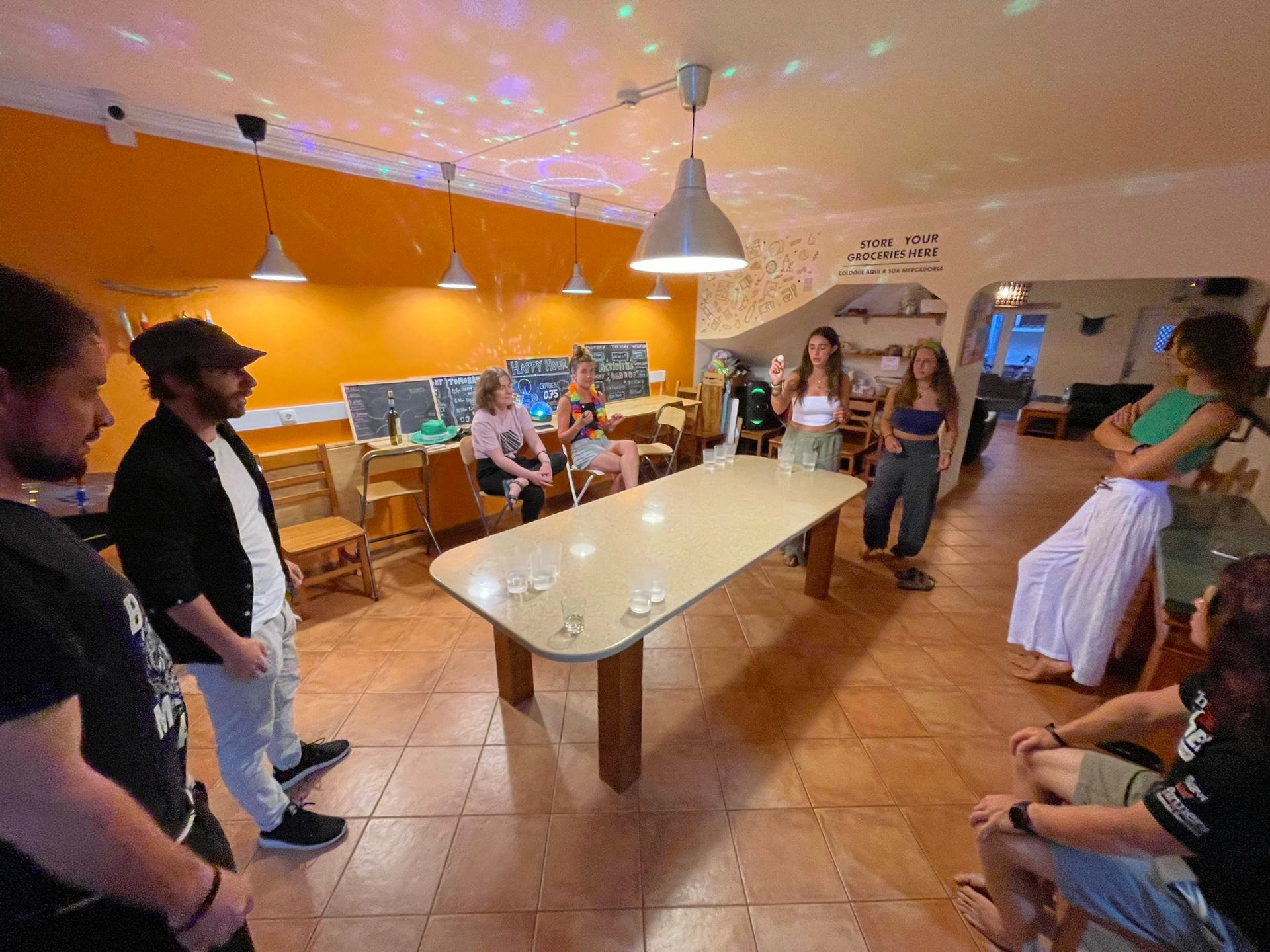 A group of people are sitting around a table in a room.