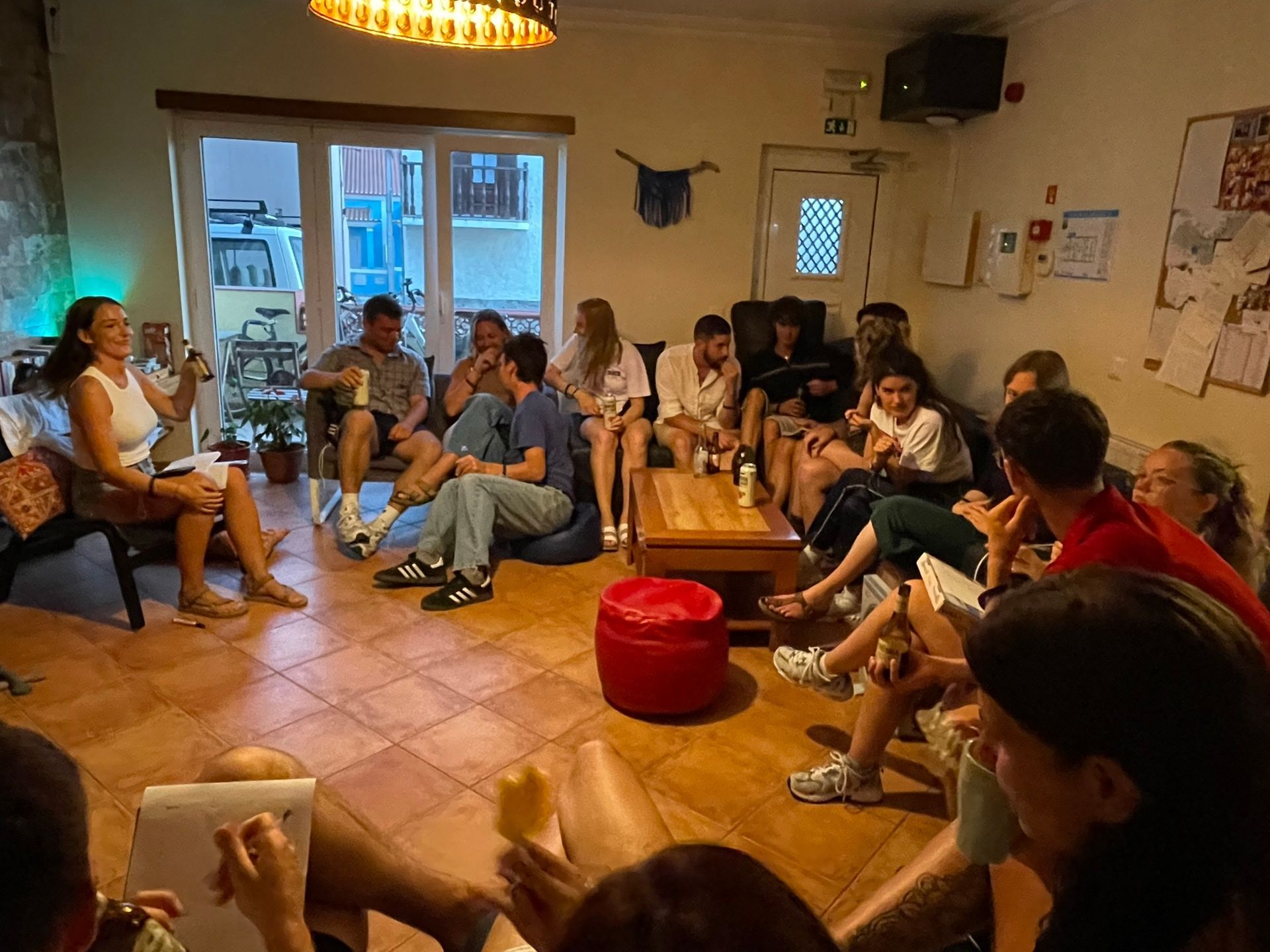 A group of people are sitting in a circle in a living room.