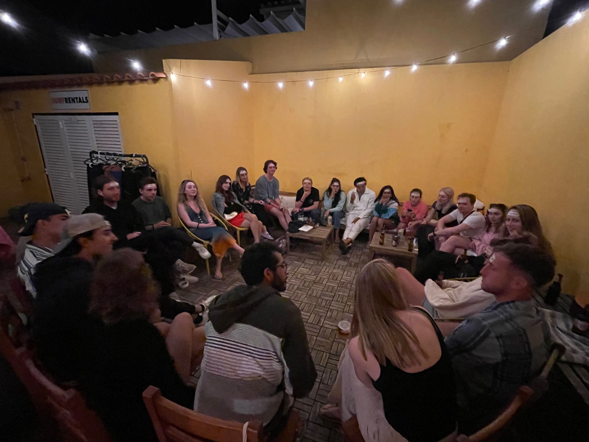 A group of people are sitting in a circle in a room.