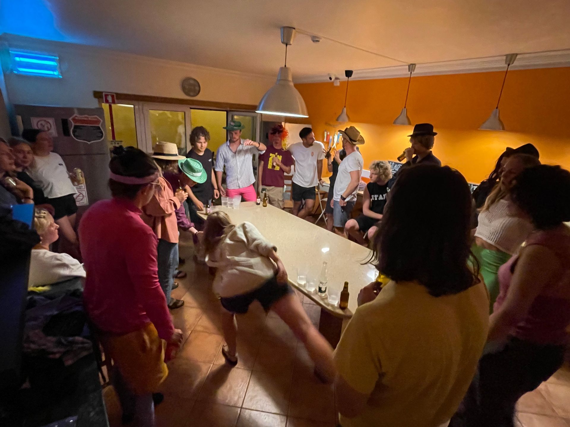A group of people are standing around a table in a room.