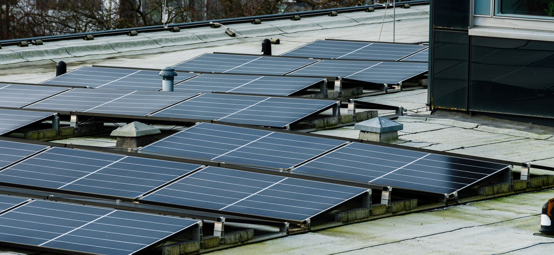 Rooftop solar panels covered in snow on a winter day