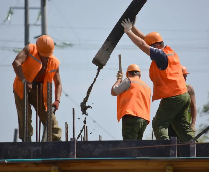 Construction Workers Pouring Concrete at a Construction Site— Bampak In Coolum Beach QLD