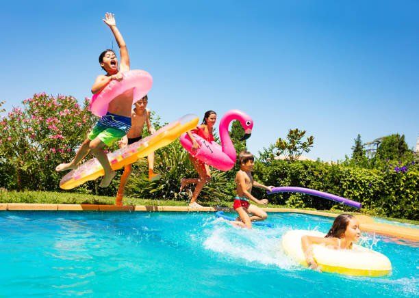 happy family playing in pool