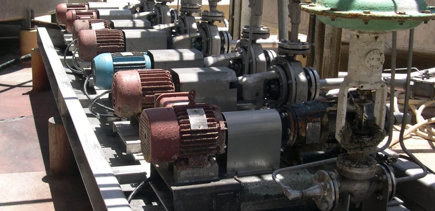 A Row Of Pumps Are Lined Up In A Factory — Canary North Pty Ltd In Annandale, QLD