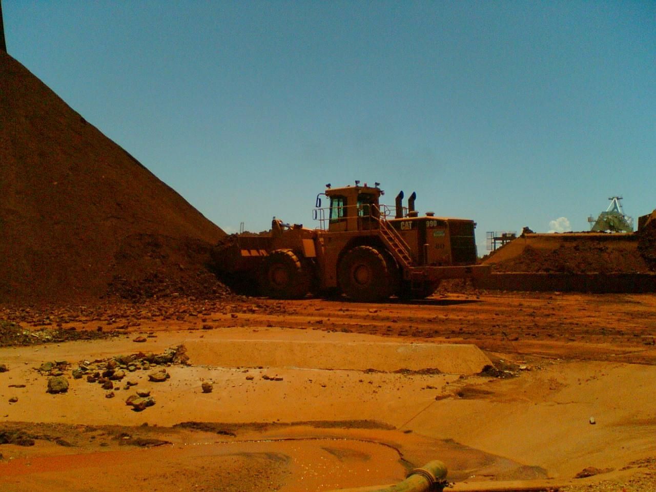 A Bulldozer Is Moving Dirt In Front Of A Large Pile Of Dirt — Canary North Pty Ltd In Annandale, QLD