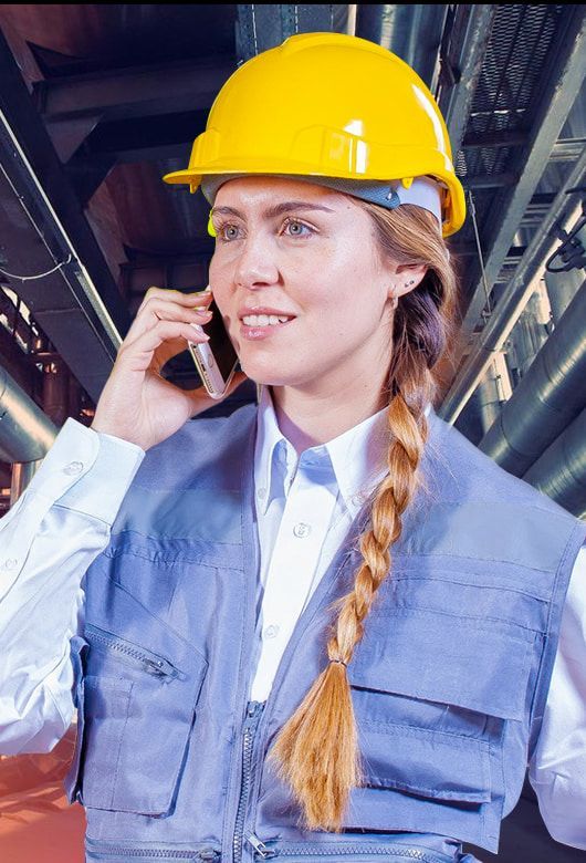 A Woman Wearing A Hard Hat Is Talking On A Cell Phone — Canary North Pty Ltd In Annandale, QLD