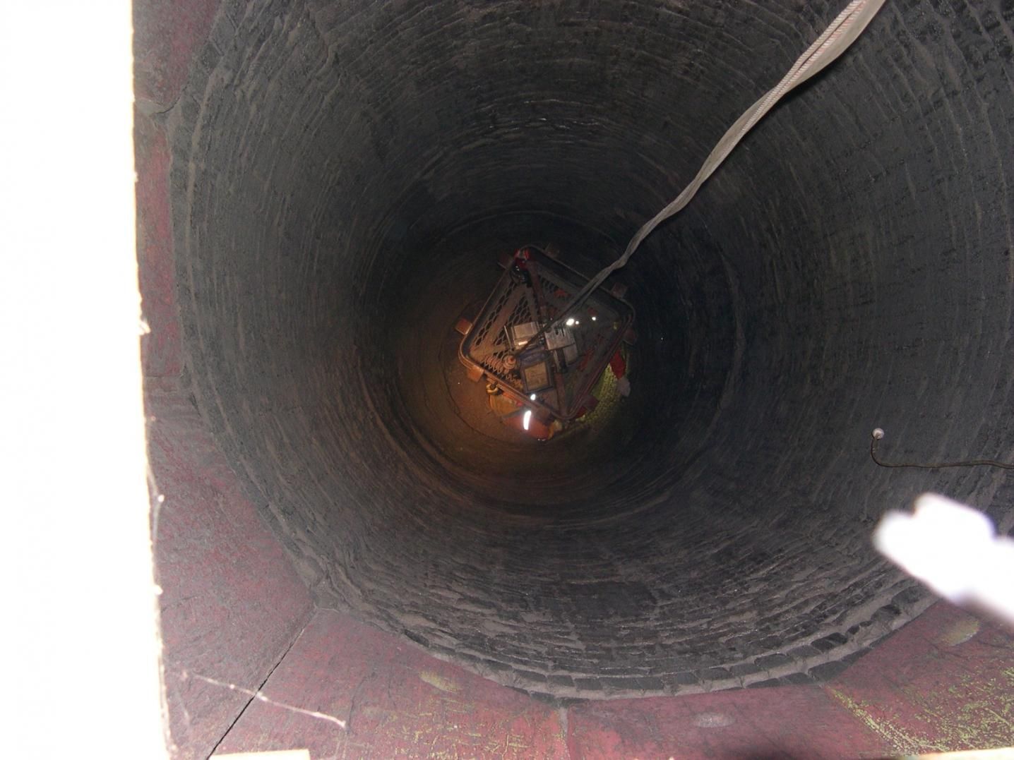 A Group Of People Are Looking Down Into A Well — Canary North Pty Ltd In Annandale, QLD