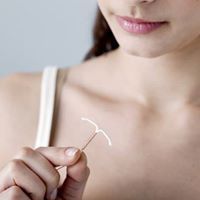 Women holding birth control device