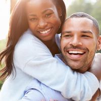 African American woman and man hugging
