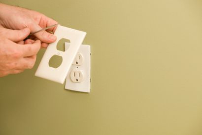 Electric Repair Services — Electrician Repairing the Outlet in Sumner, WA