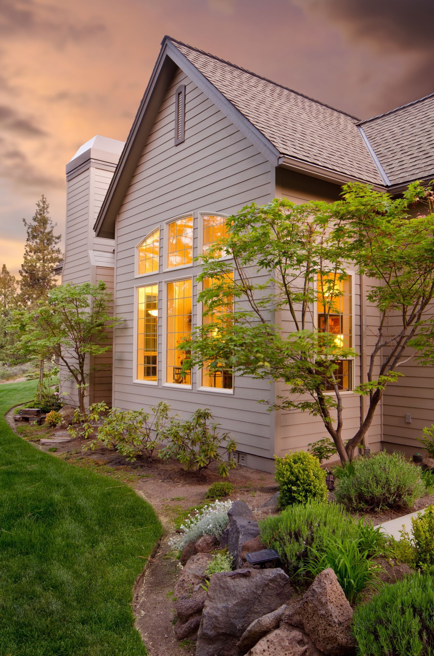 A large house with a lot of windows and trees in front of it.