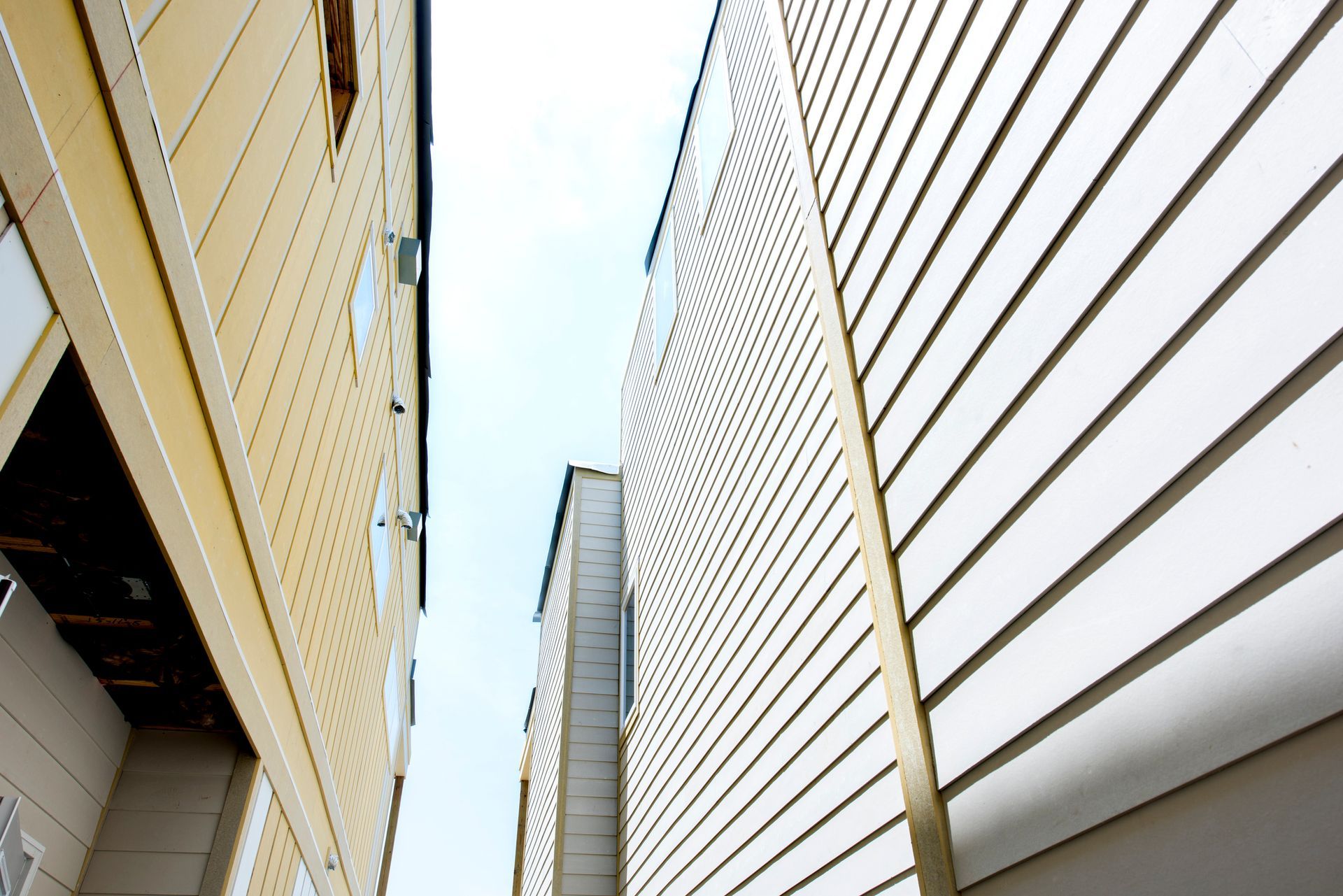 Looking up at the side of a building with a blue sky in the background.