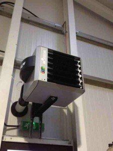 a large heater is hanging from the ceiling of a building .