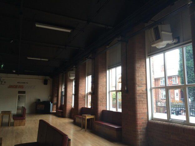 a large room with lots of windows and brick walls