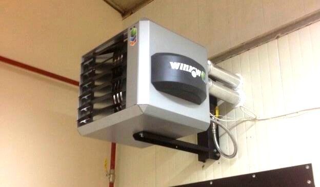 A heater is hanging from the ceiling of a building.