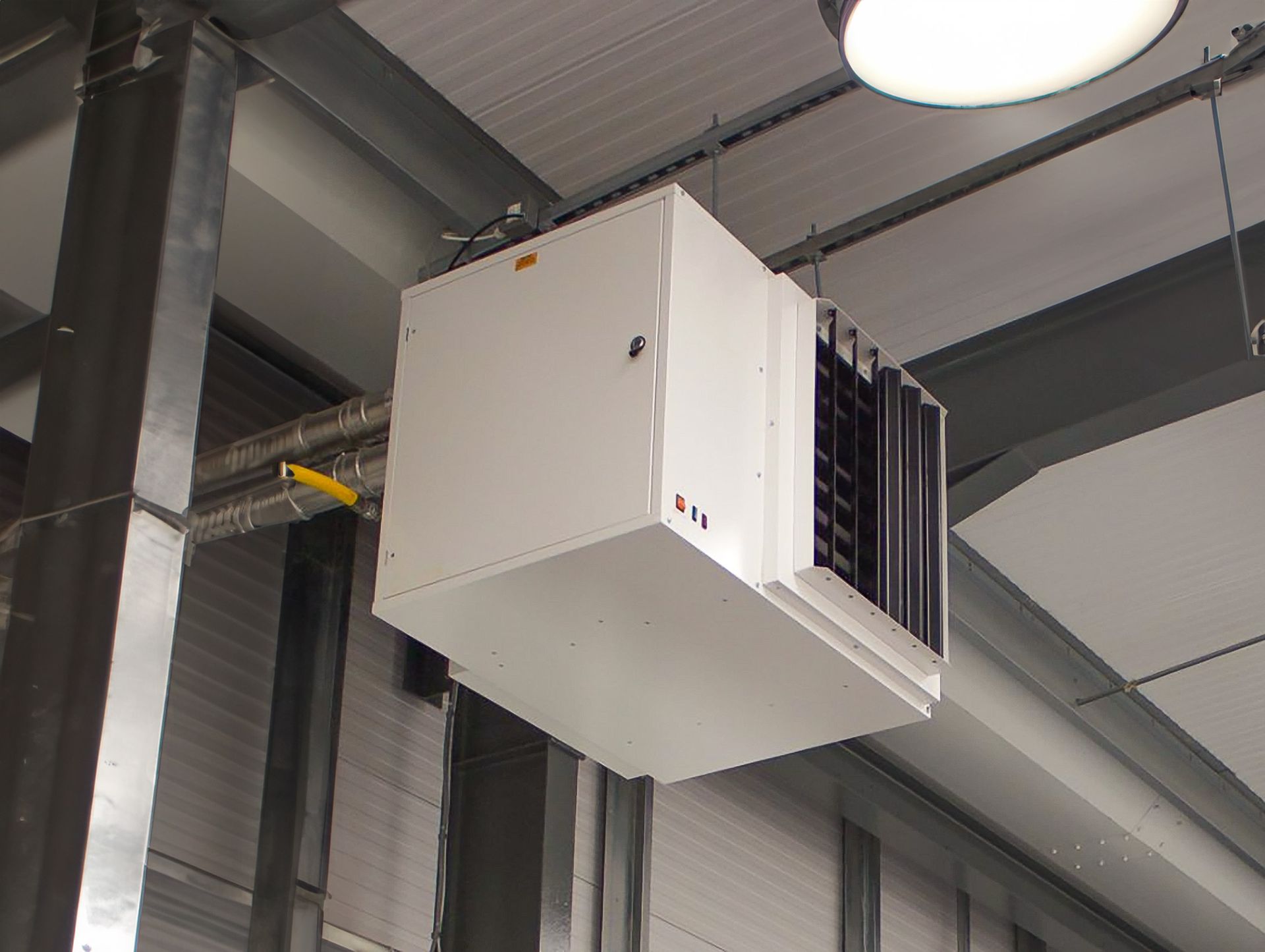 A large white box is hanging from the ceiling of a building