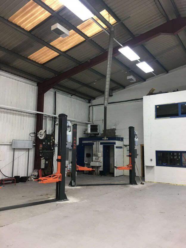Motor Range Car Dealership Heating car garage warehouse with two lifts in the middle of it