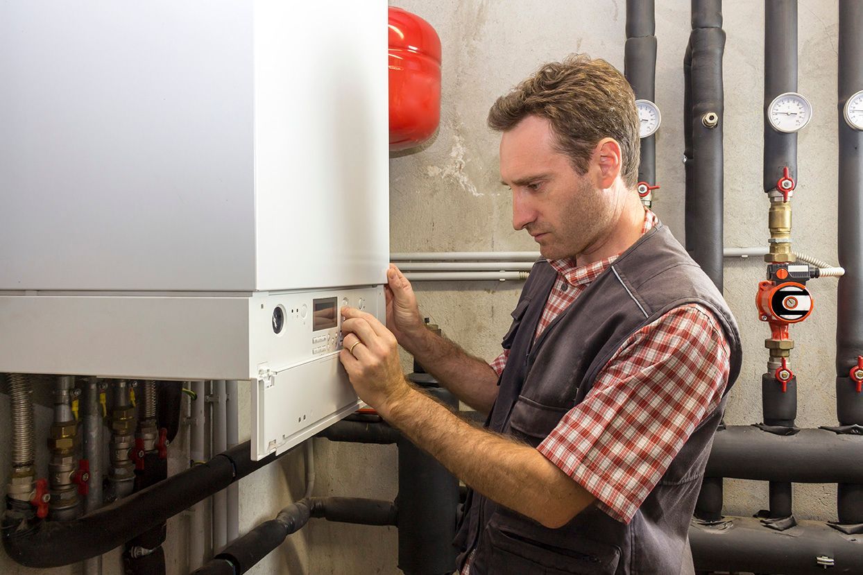 Gas engineer inspecting boiler