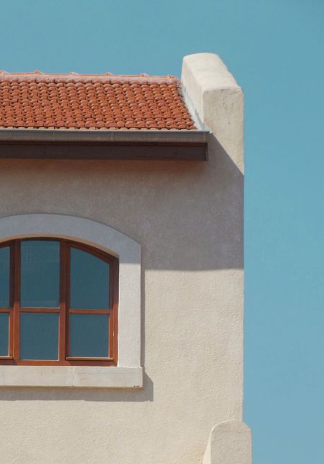 Stucco siding on a Spring Valley, NV, home with a tile roof and Mediterranean-style architectural detail