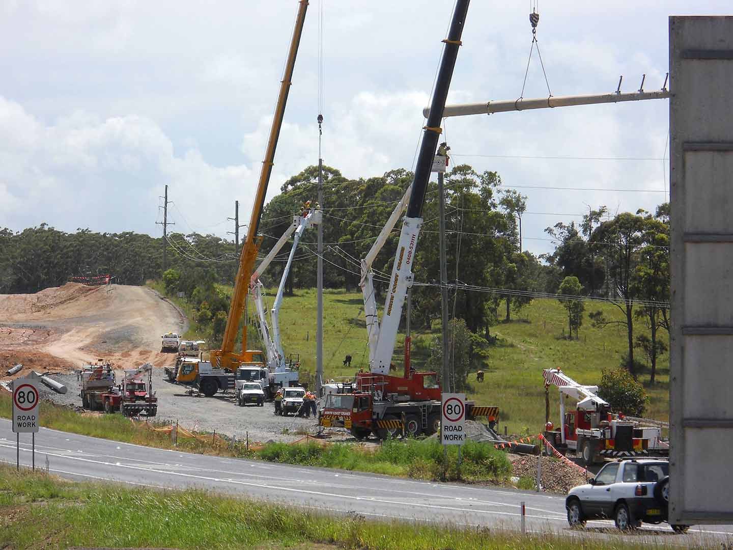 A Construction Site With A Lot Of Trucks And Cranes — North Coast Cranes In Bellingen, NSW