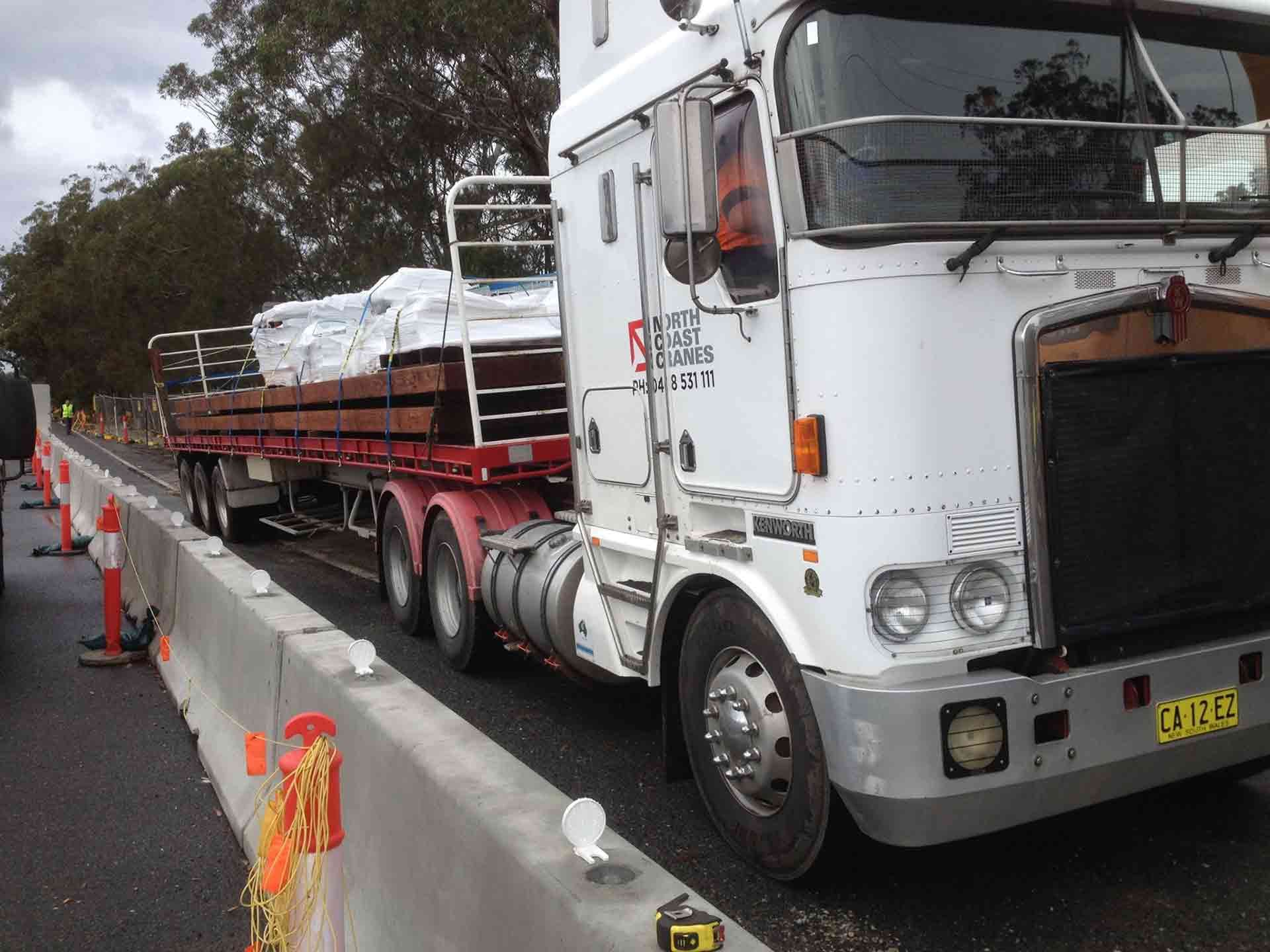 A White Kenworth Semi Truck Is Parked On The Side Of The Road — North Coast Cranes In Armidale, NSW