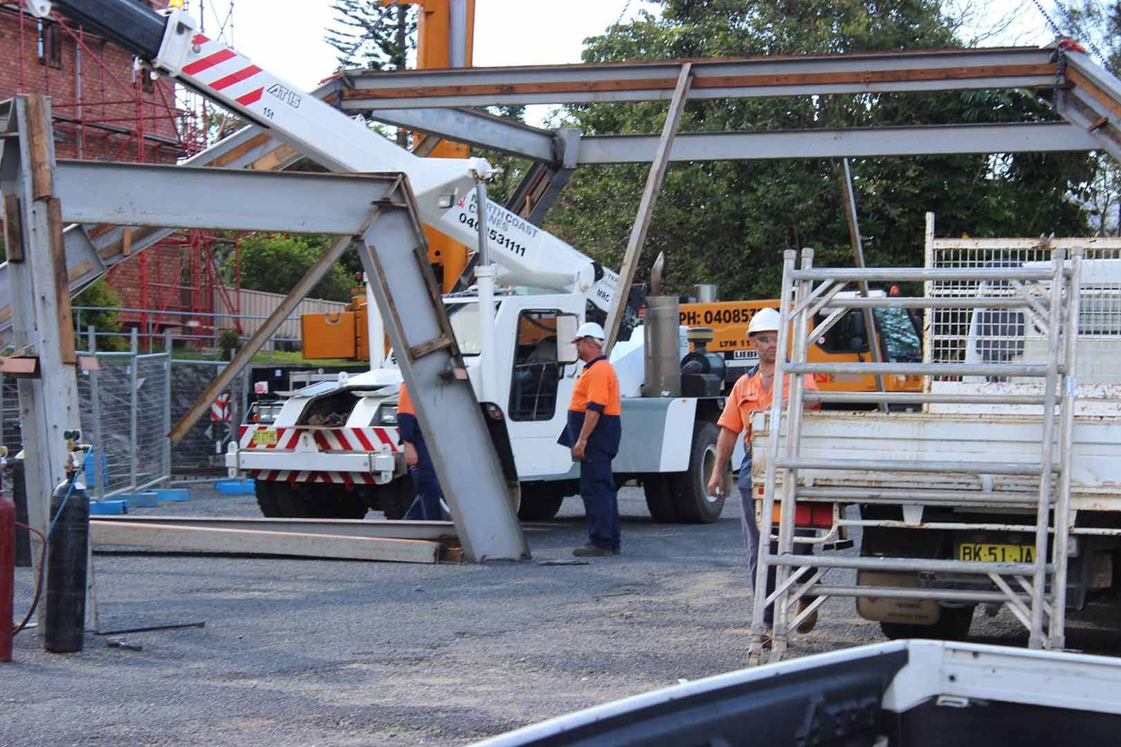 A White Crane Truck In A Construction Field — North Coast Cranes In Coffs Harbour, NSW