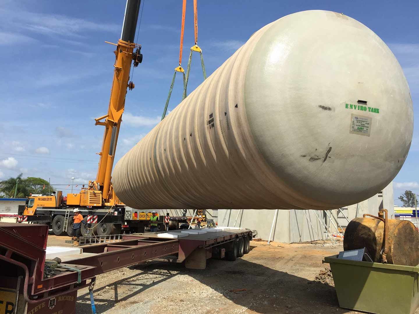 A Large White Tank Is Being Lifted By A Crane — North Coast Cranes In Grafton, NSW