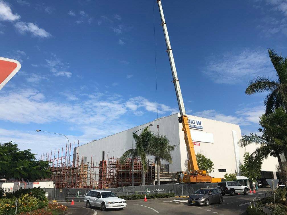 A Large Crane Is Sitting In Front Of A Building Under Construction — North Coast Cranes In Grafton, NSW
