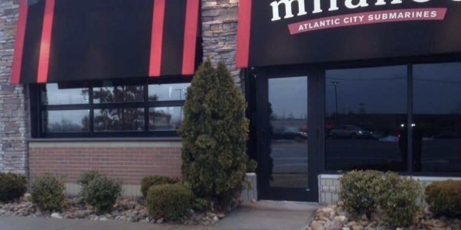 A building in Fairfield, Ohio, with a sign that says 'Milano's,' showcasing commercial window tinting services