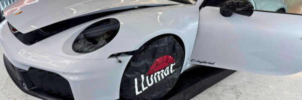 White sports car receiving LLumar paint protection film installation