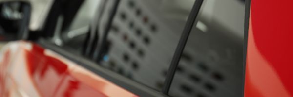 Close-up of tinted vehicle windows with LLumar no-fault replacement coverage
