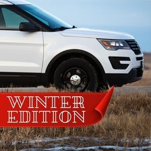A white SUV with window tint is parked in a snowy field during winter in Fairfield, Ohio