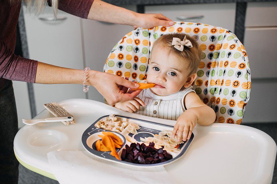 woman feeding the baby