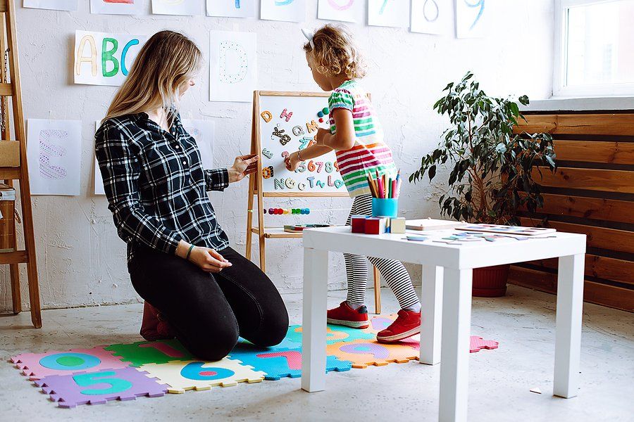 kid holding the toy letters