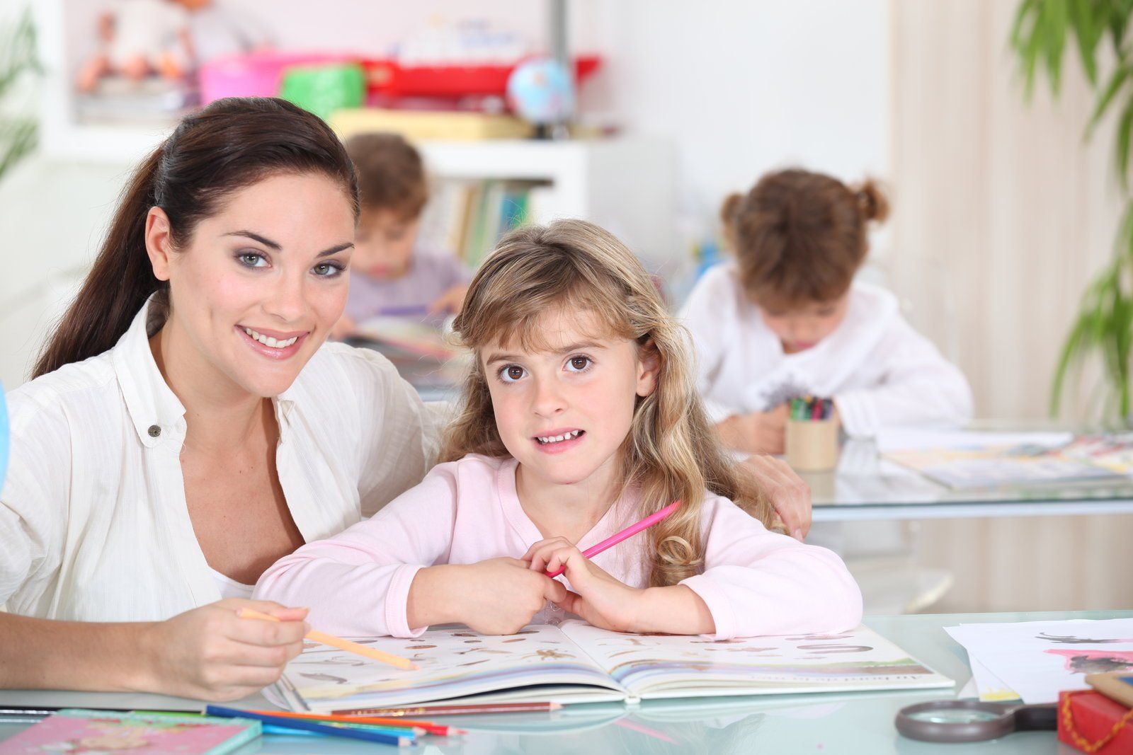 woman teaching the kid how to read