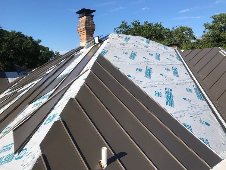 Standing seam metal roof installation in progress Standing seam metal roof installation in progress