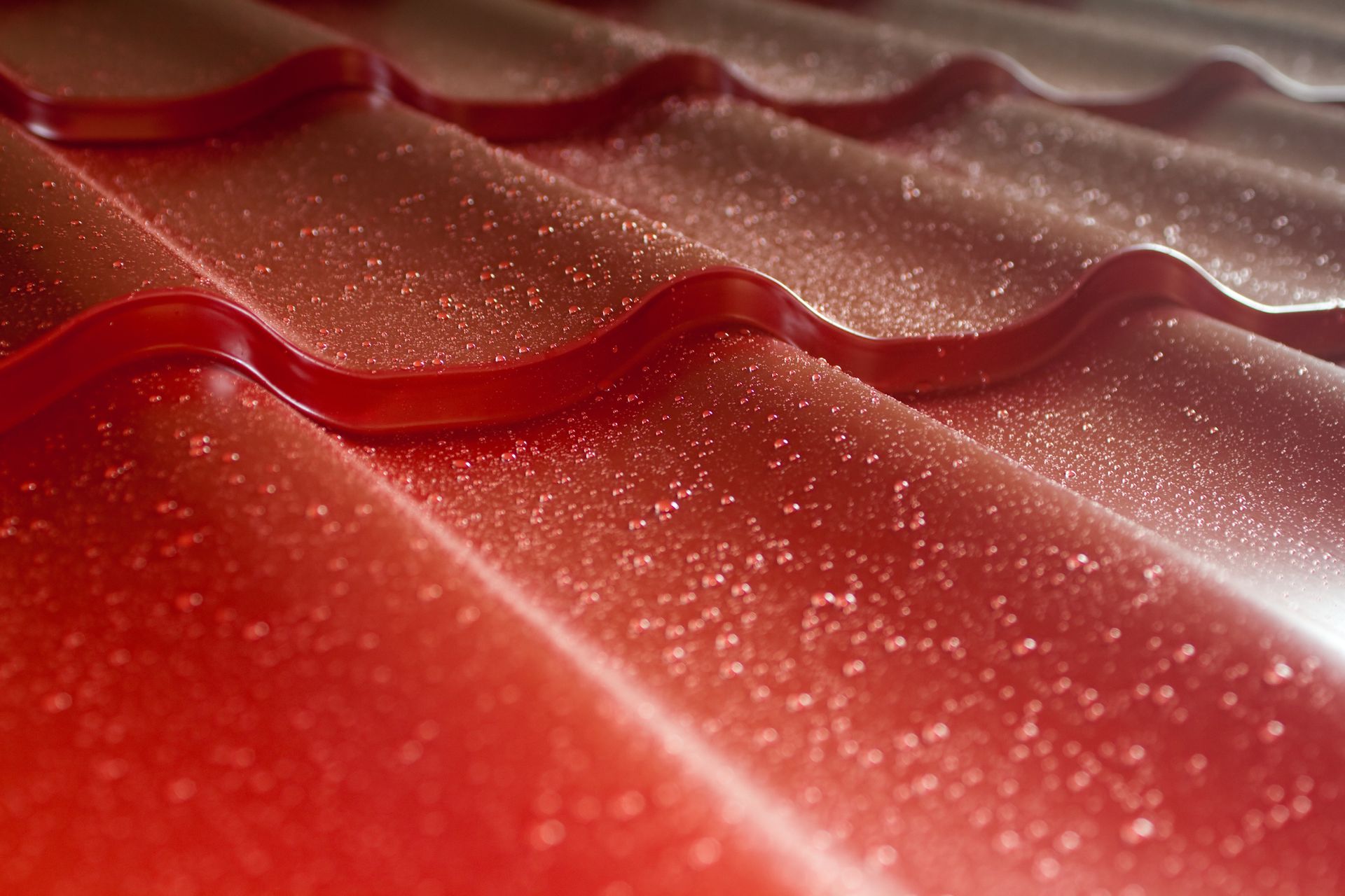 Red corrugated metal roof with white frost.