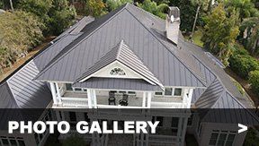 Roofing Shingles — Residential Roof in Savannah, GA Gray metal roof on a house with a porch and